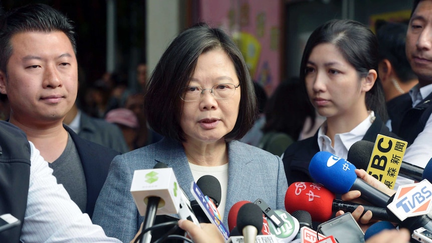 Taiwanese President Tsai Ing-wen behind a myriad of journalists' microphones in New Taipei City, Taiwan.