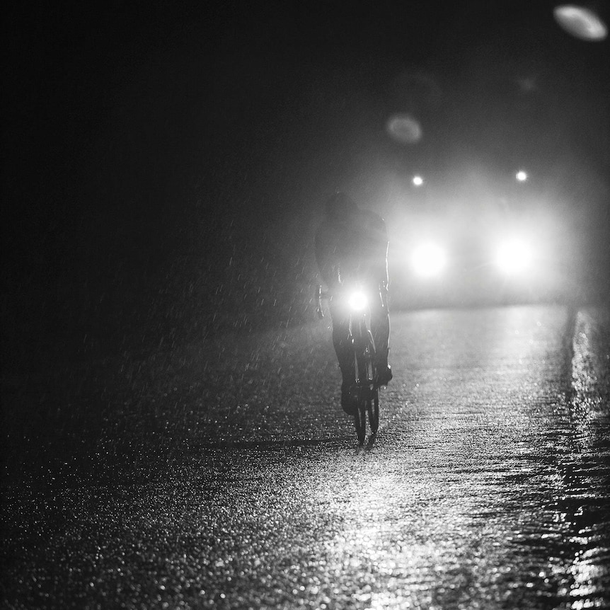 Mark Beaumont rides at night in the rain