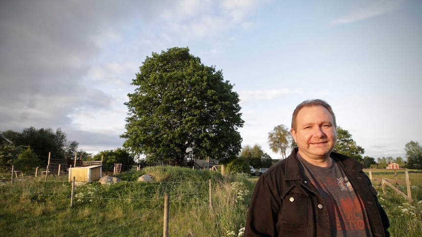 Scott Goodwin standing in front of his property