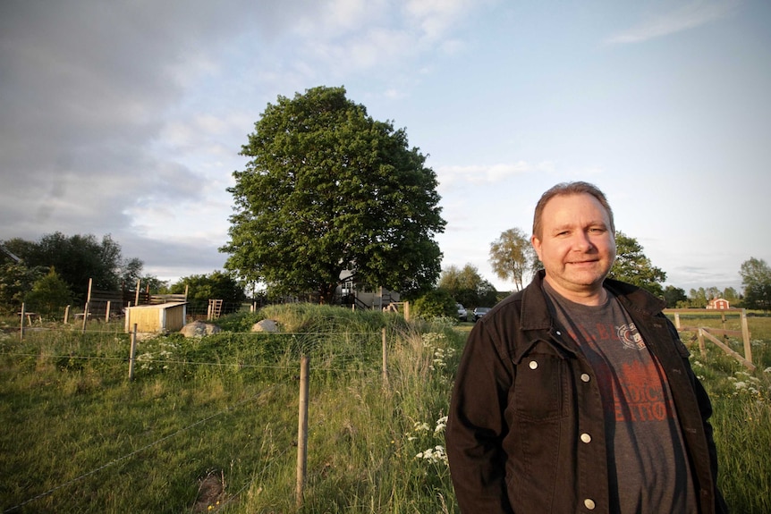 Scott Goodwin standing in front of his property