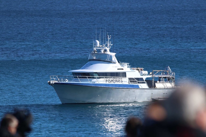 A fisheries boat in the water.