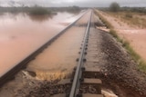 A rail line covered in muddy water