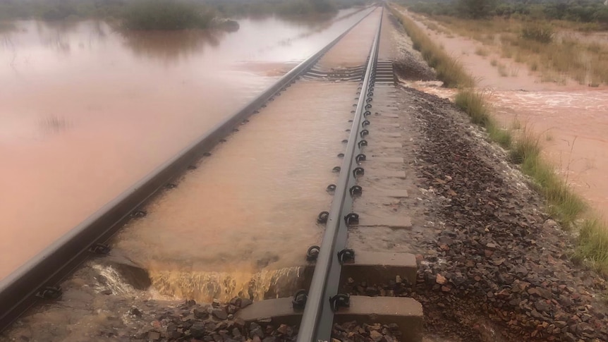A rail line covered in muddy water