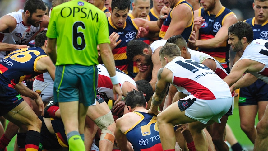 Adelaide Crows and Melbourne Demons in three-quarter-time melee