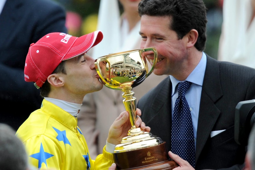 Trainer and jockey celebrate Melbourne Cup win.