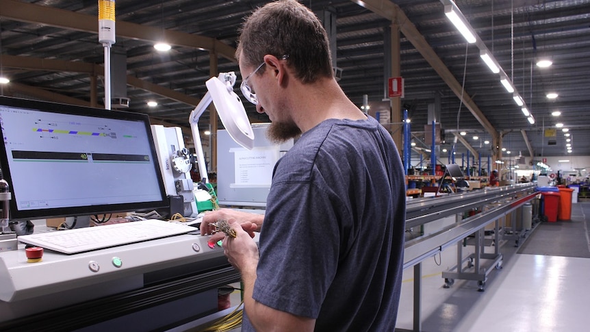 A worker in the AME systems advanced manufacturing plant for automotive wiring in Ararat