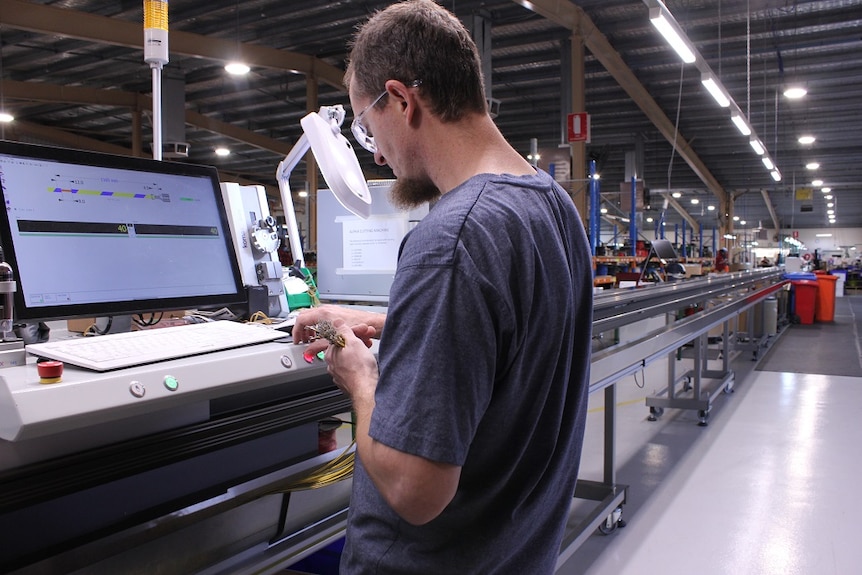 A worker in the AME systems advanced manufacturing plant for automotive wiring in Ararat