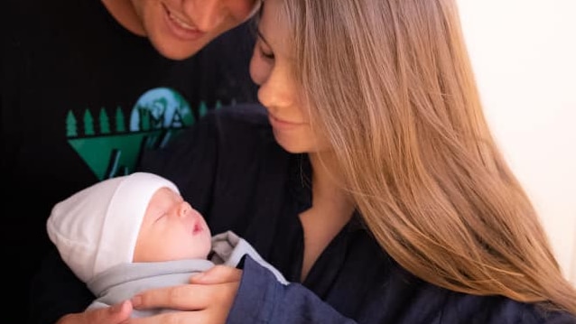 Bindi Irwin and Chandler Powell holding newborn daughter