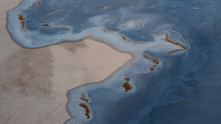 Blue water mixes with salt on Lake Eyre.