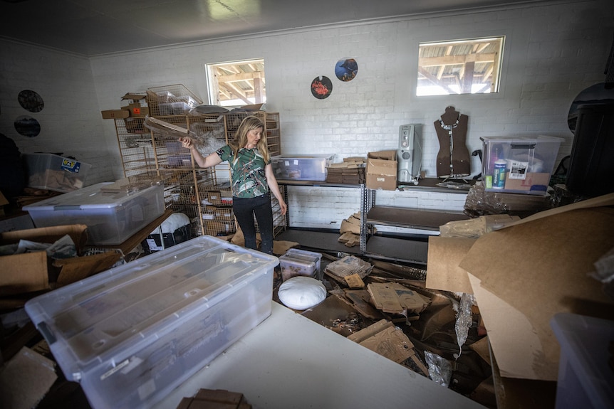 Tamika Bannister surveys flood damage at Spotted Quoll Studios.