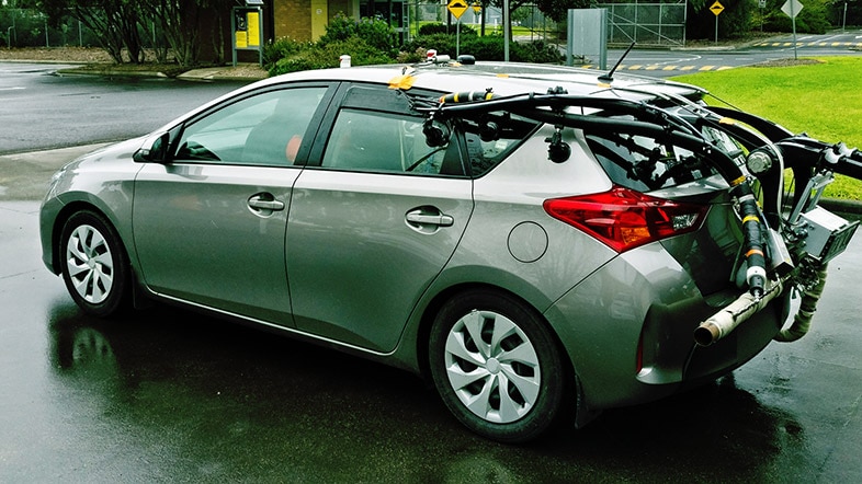 A hatchback car is fitted with a device made of several tubes and monitoring equipment.