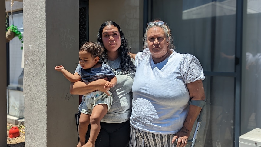 Cherie Nannup stands outside her rental with her grand-daughter Whitney, who is holding her own young son. 