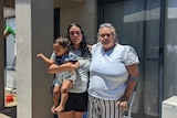Cherie Nannup stands outside her rental with her grand-daughter Whitney, who is holding her own young son. 