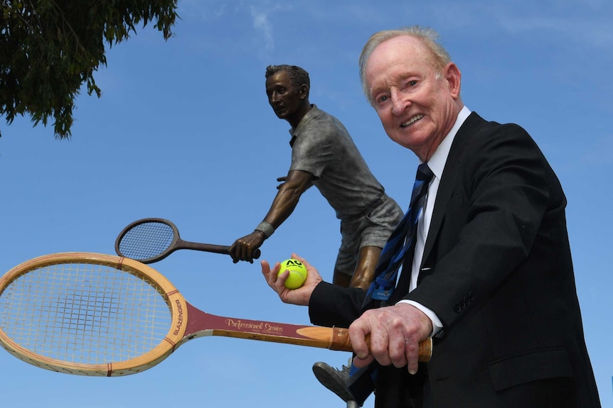 Rod Laver next to a statue of himself at Rod Laver Arena in Melbourne