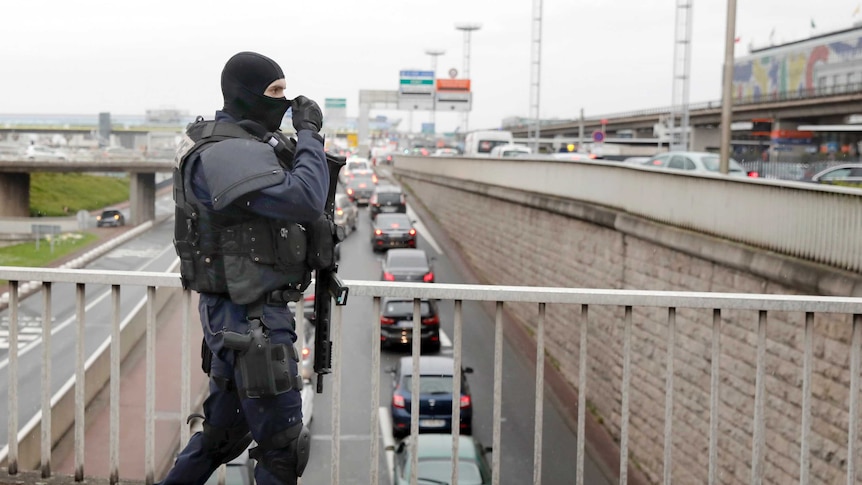 A gendarmes officer patrols the airport after the incident