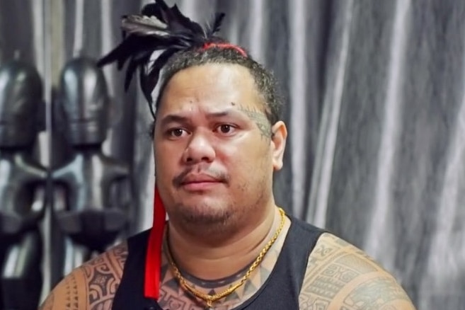 Tahitian tattooist Patu wearing a feather in his hair 