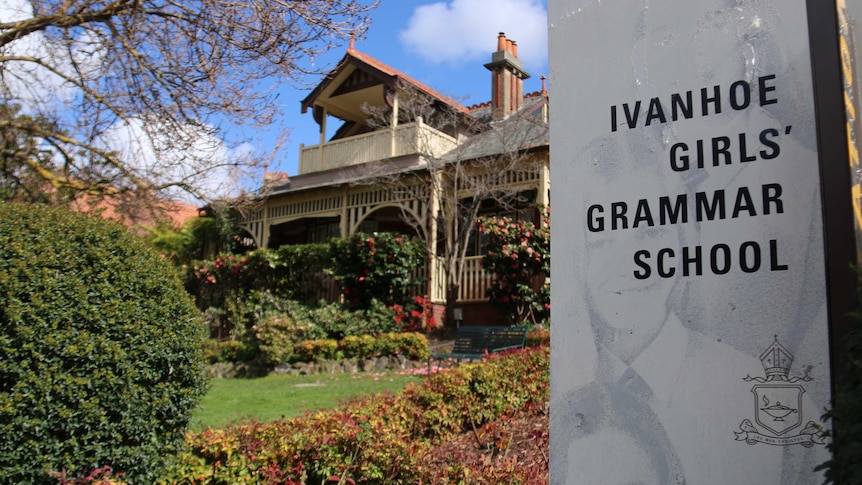An image of the Ivanhoe Girls' Grammar School sign with school in background on a sunny day.