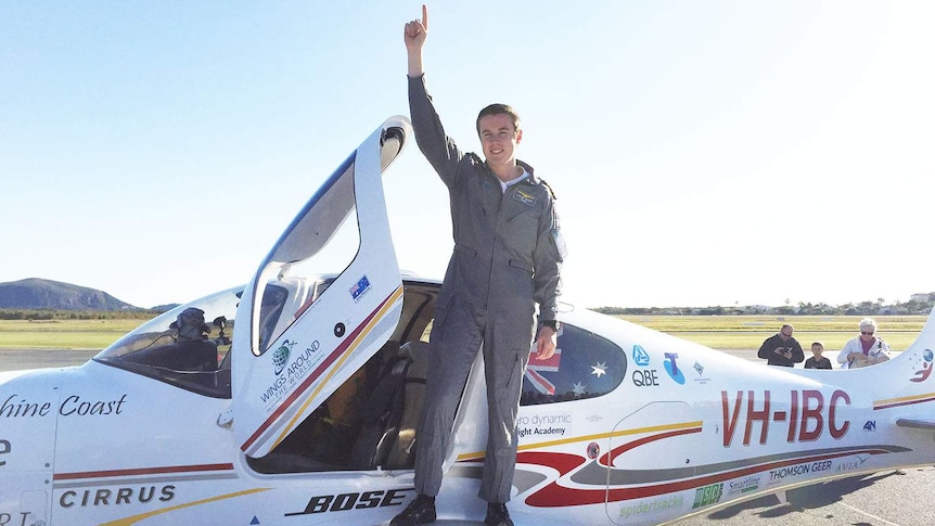 Lachlan Smart jubilant on the wing of his plane
