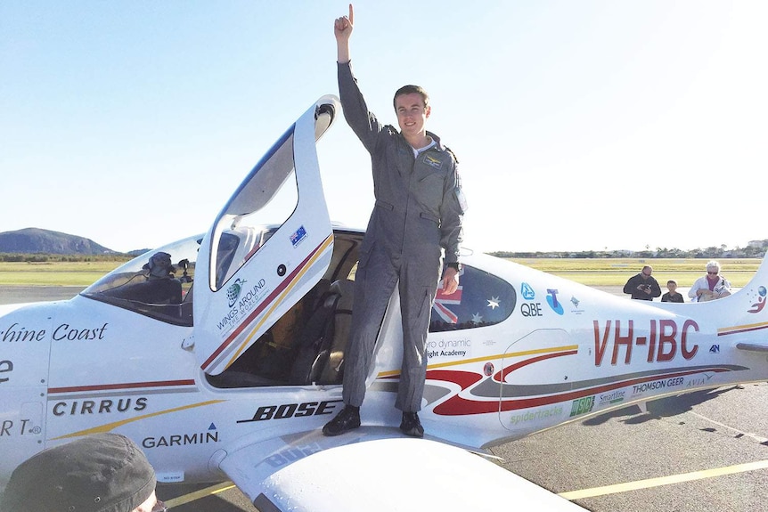 Lachlan Smart jubilant on the wing of his plane