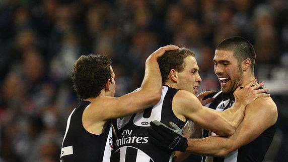 Brent Macaffer is congratulated on a goal for the Pies.