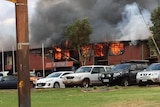 Flames consume the west wing of Newman Senior High School.