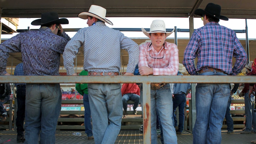 For the 2016 Open Bull Ride Champion, Jared Boghero, standing between three men all in blue jeans and wide hats.
