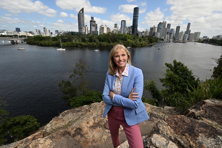 Cindy Hook, CEO of the Brisbane 2032 Olympic and Paralympic Games, smiling with CBD in the background