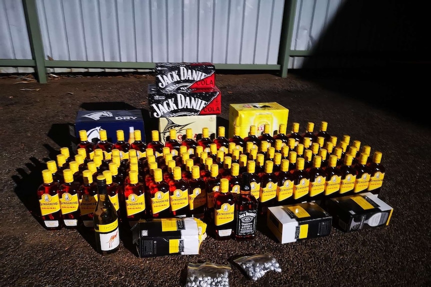 Several dozen bottles of rum and other alcohol seized by police during the coronavirus pandemic.