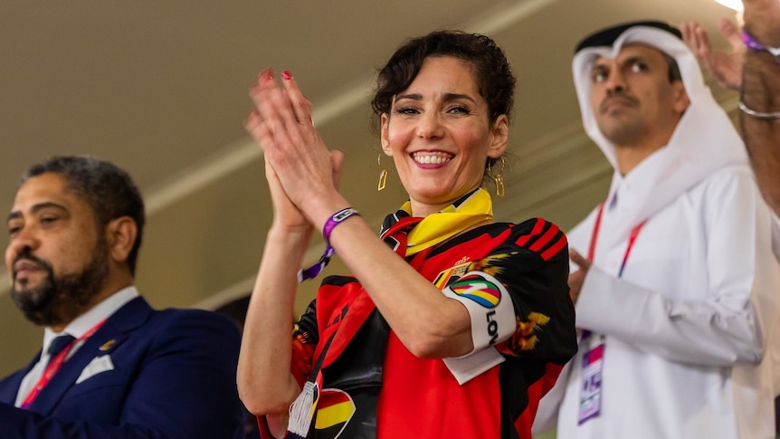 Belgian Foreign Minister Hadja Lahbib applauds while wearing a pro-LGBT OneLove armband at the Qatar World Cup.