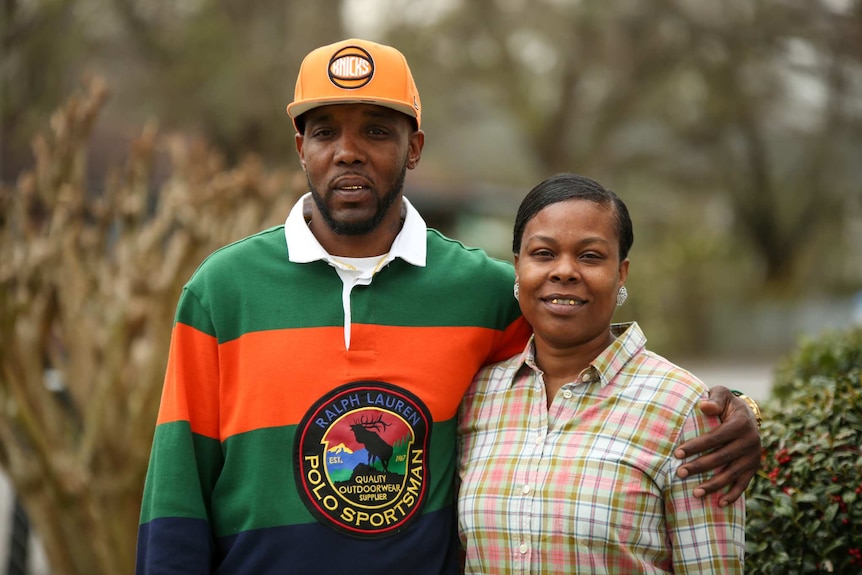 An African American man with his arm around a smiling woman