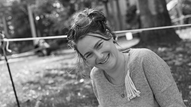 Melbourne-based Tahlia Mandie sits on the grass at a park