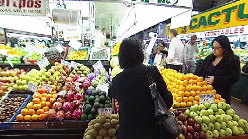 A consumer persuses fruit and vegetable displays at an Adelaide market.