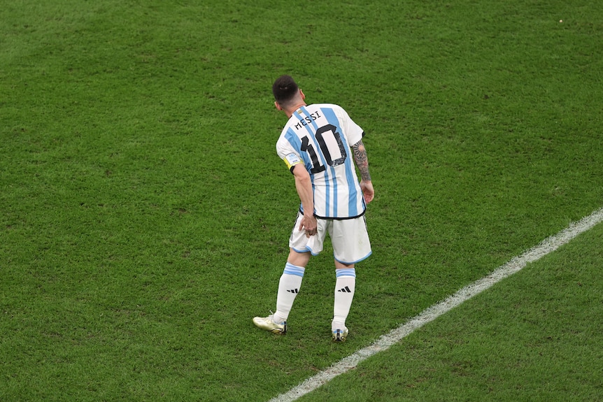 Argentina's Lionel Messi grabs his left hamstring while on the field during the FIFA World Cup semifinal against Croatia.