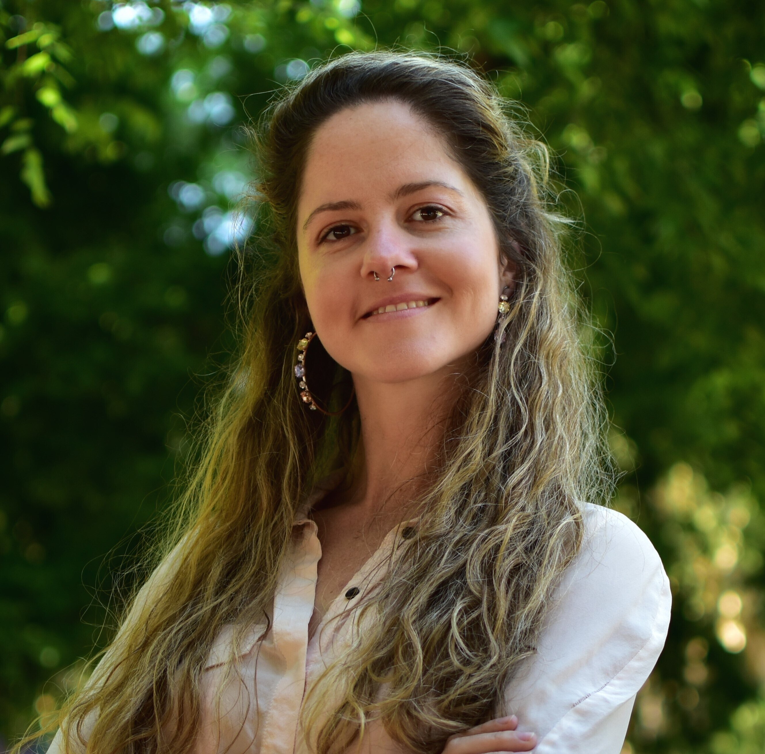 A woman with blonde/brown hair smiles to camera