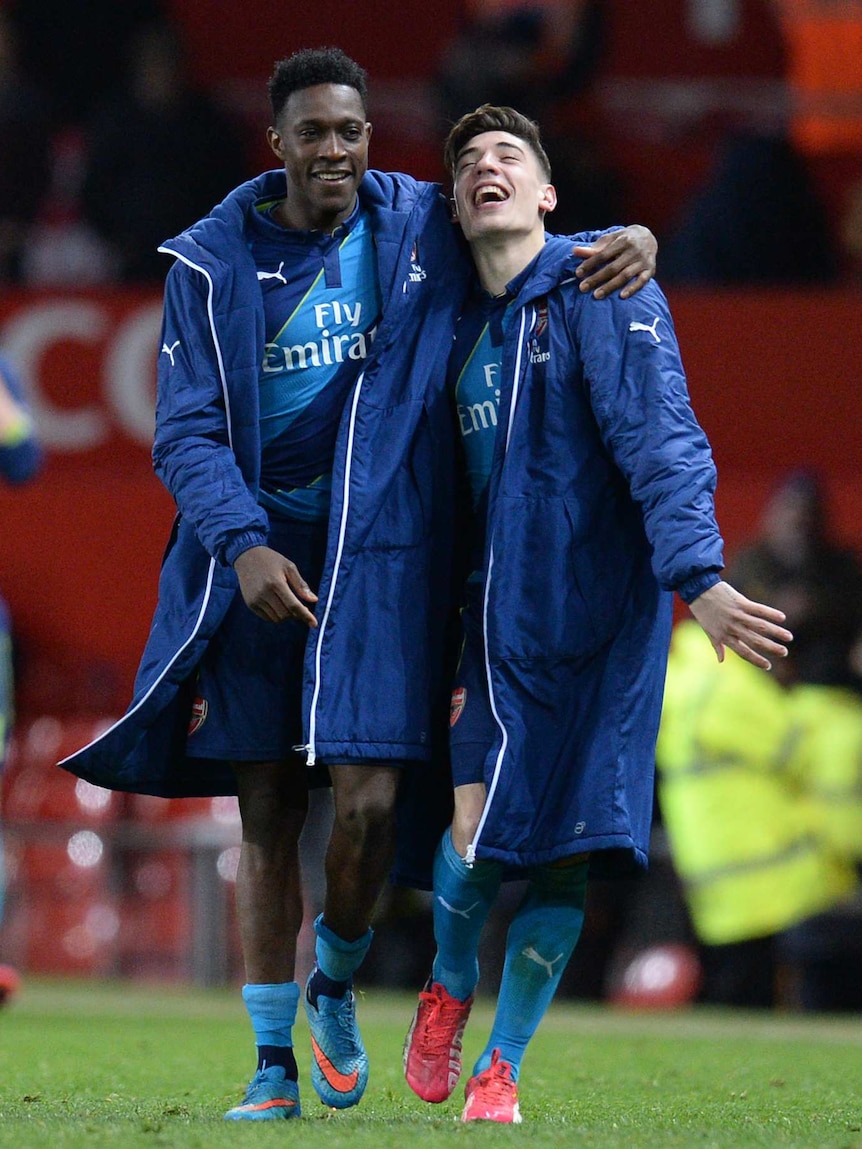 Danny Welbeck and Hector Bellerin leave the pitch after beating Manchester United