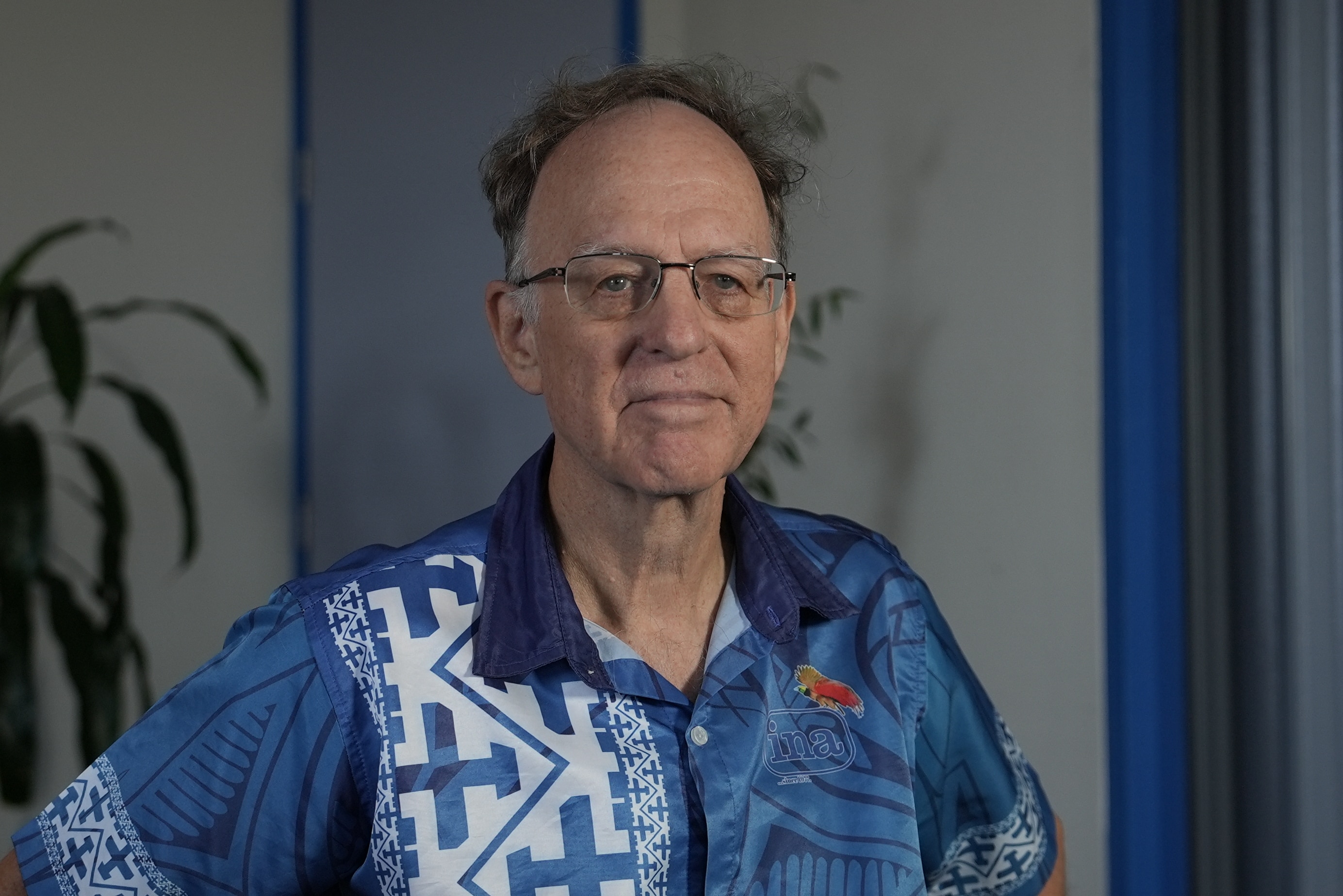 A man smiles in a portrait.