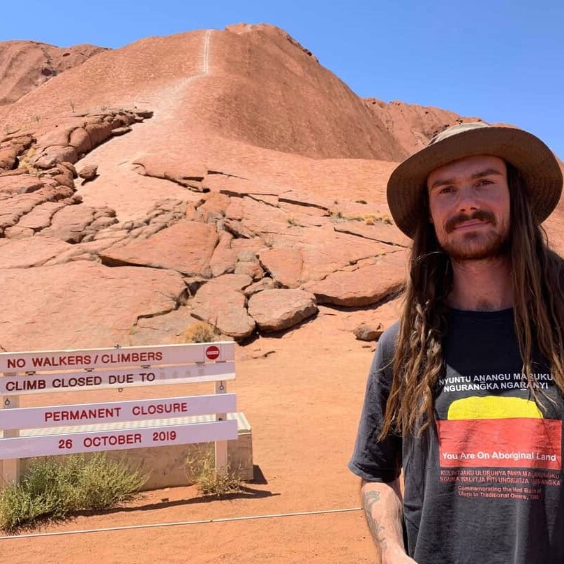 Wilderness Guide Matt Wesley in front of the "no climbing" sign at Uluru