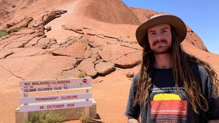 Wilderness Guide Matt Wesley in front of the "no climbing" sign at Uluru