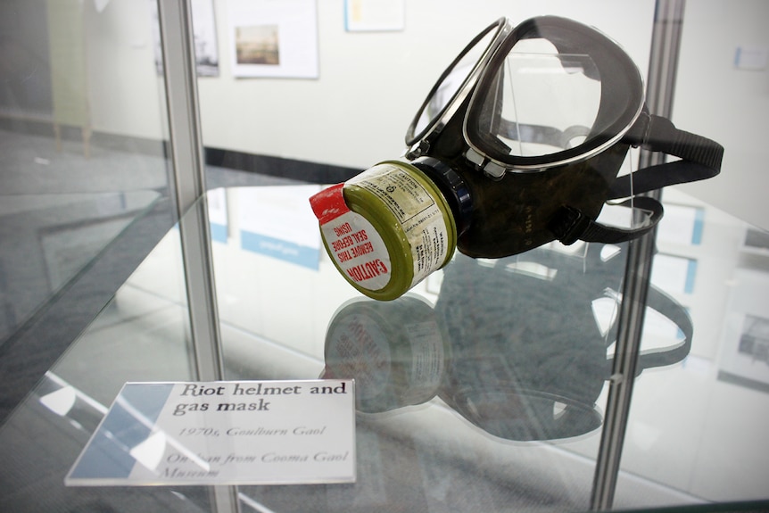 A gas mask from Goulburn Gaol in a glass display cabinet.