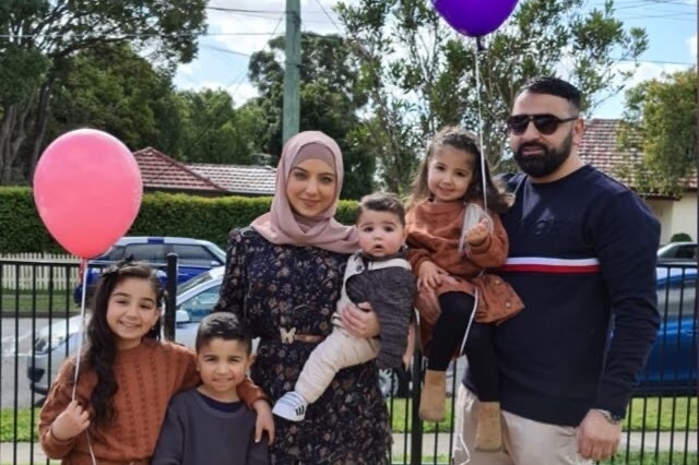 Rana Elasmar, wearing a hijab, with her husband and four children.