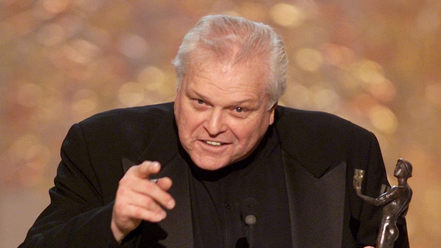 Actor Brian Dennehy holds his award for best actor while on stage.