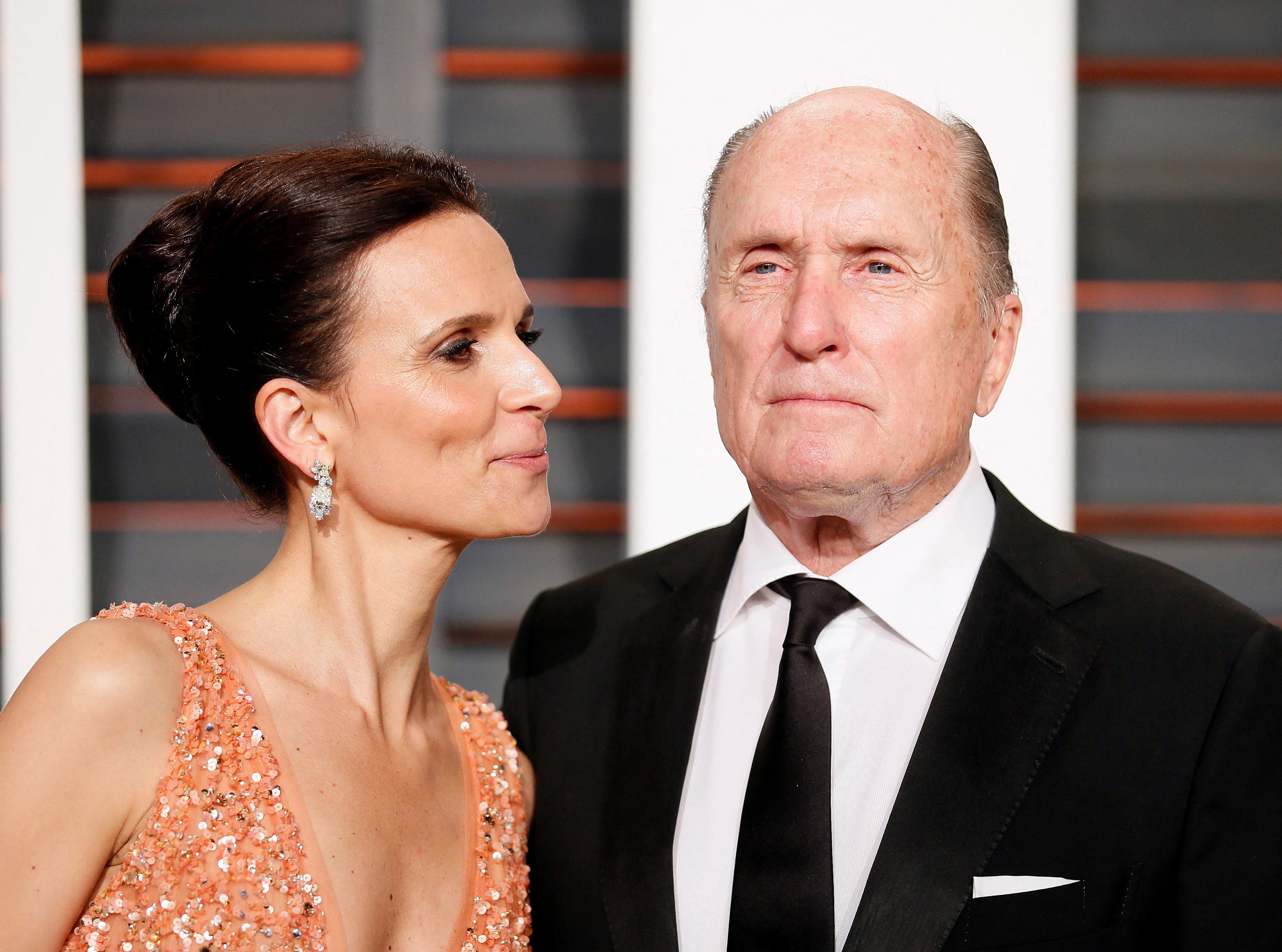 Actor Robert Duvall and wife, Luciana Duvall, arrive at the 2015 Vanity Fair Oscar Party.