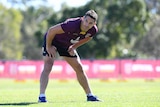 Billy slater stretches at a Queensland Maroons training session.