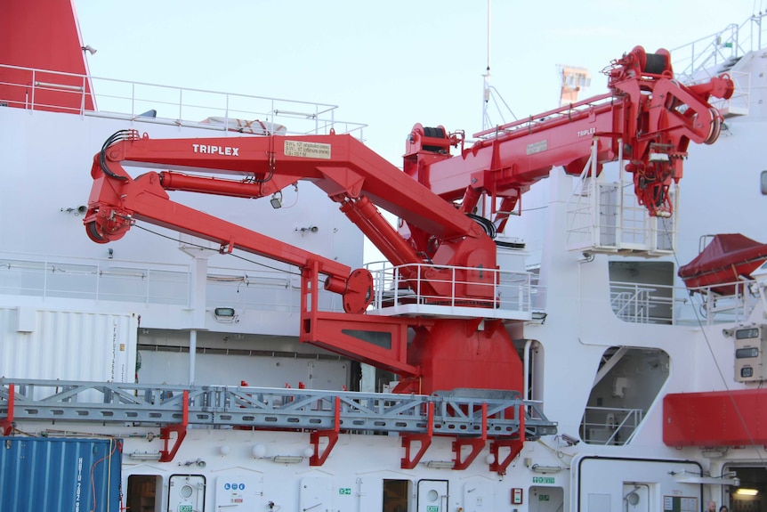 A close-up of large red cranes on the German deep sea research vessel, RV Sonne.