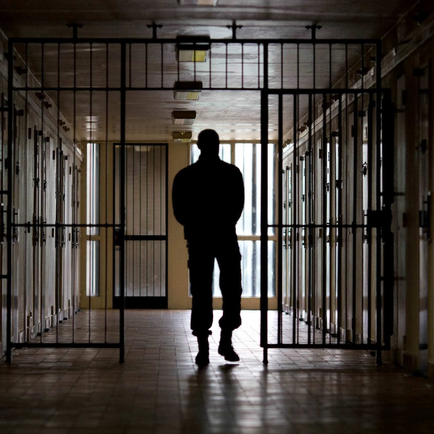 a man walking through a prison