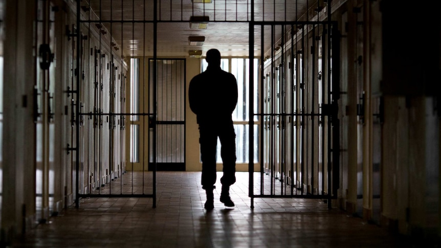 A warden patrols in the corridors of the Bois d'Arcy jail on July 8, 2014, near Paris.