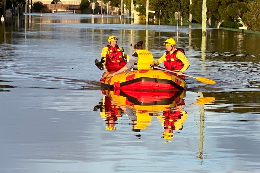 Queensland Fire Emergency and Rescue swiftwater technicians in rubber dinghies assist evacuation of residents from Warwick homes