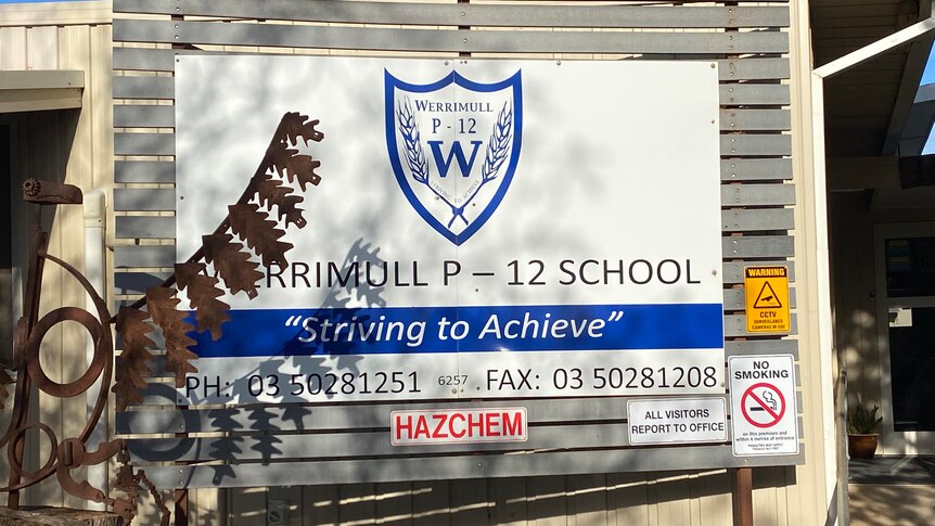 Sign for Werrimull P-12 school, its moto reads "Striving to Achieve."