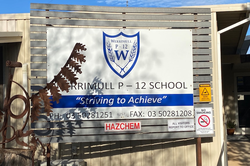 Sign for Werrimull P-12 school, its moto reads "Striving to Achieve."