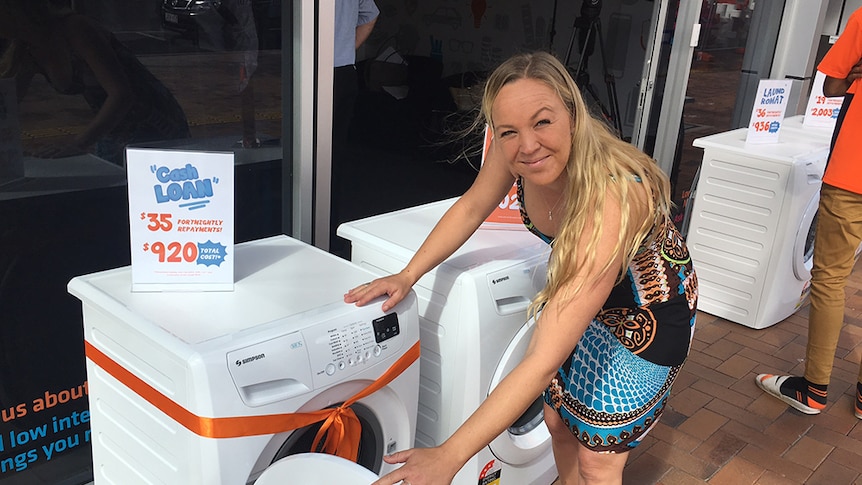 Gold Coast single mother Rachel Lewis checks out a washing machine